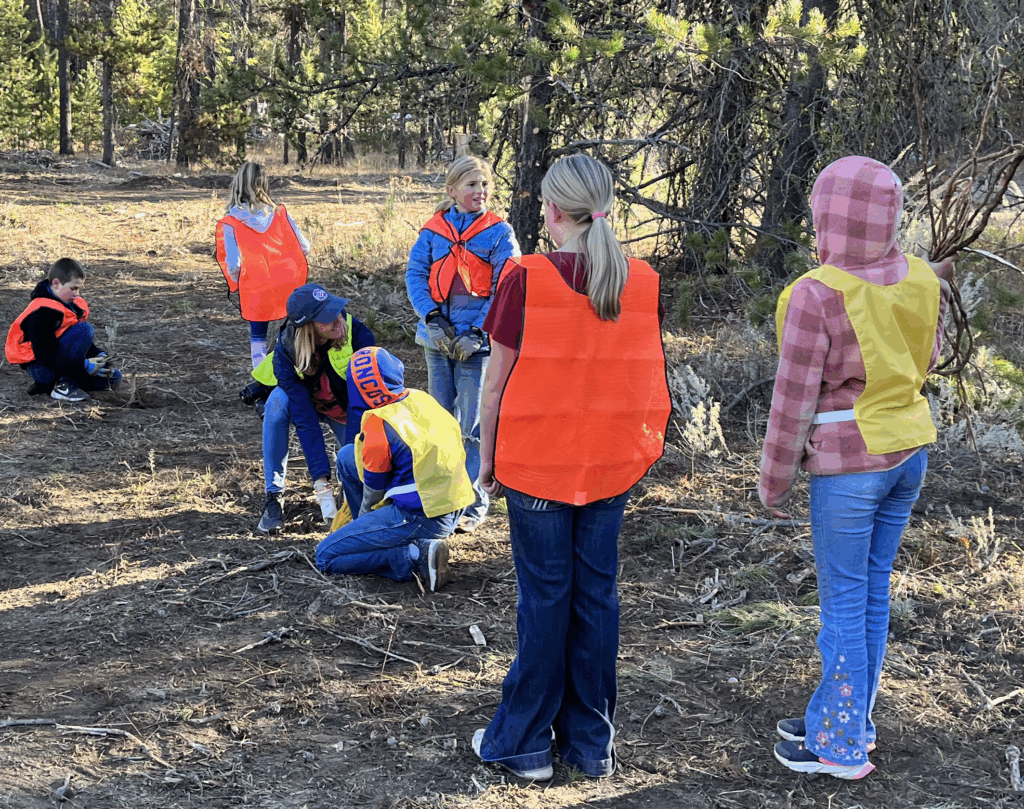 Donnelly Elementary kids pick up sticks on the trail. 